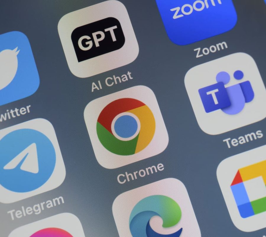 Close-up of of the icon of the Google Chrome artificial intelligence Internet browser app logo on a cellphone screen. Surrounded by the app icons of Twitter, ChatGPT, Zoom, Telegram, Teams, Edge and Meet.